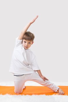 Children's yoga. The little boy does exercise. 