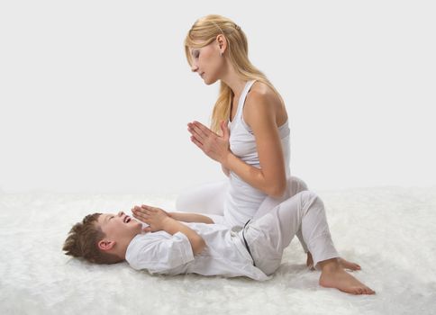 Mother and son do yoga before bed 