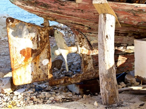 old rusry propeller on a wooden boat