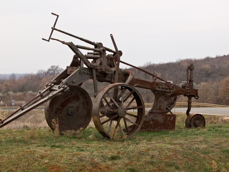 old big rusty plough parked as a monument 