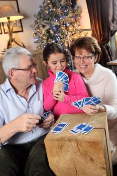 Family playing card game at Christmas