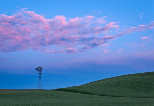 Windmill, wheat and clouds at twilight, Whitman County, Washington, USA