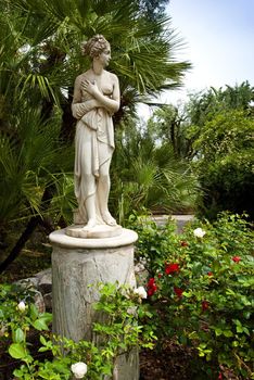 marble statue in italian gardens with palm trees