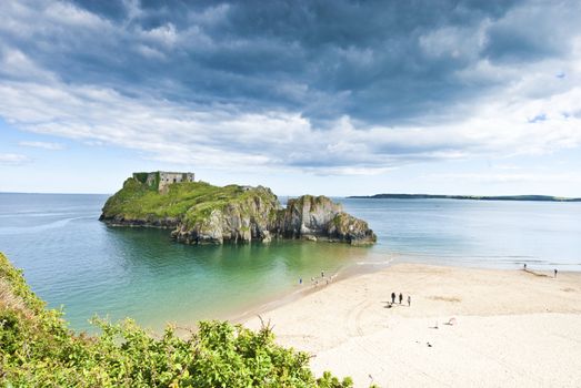 Big moody clouds over Island and beach in Tenby Pembrokeshire, Wales, Summertime