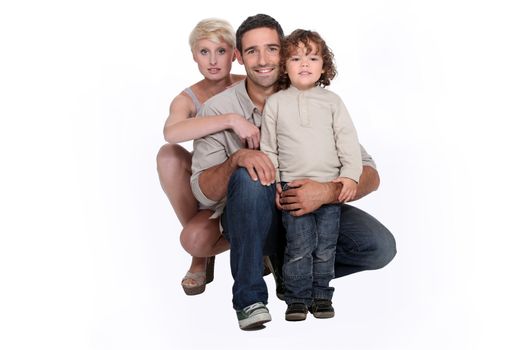 Young family posing in a studio