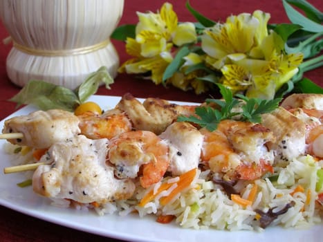 shrimps, chicken and rice on a dish 