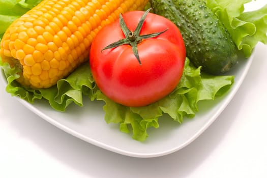 Vegetables: tomatoes, cucumbers and corn. Vivid healthy nutrition.
