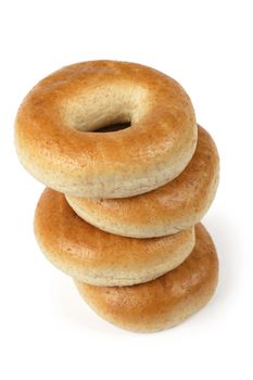 A stack of four bagels isolated on a white background.  Slight shadow visible around right side.