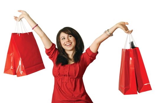 A beautiful young female holding shopping bags with a huge grin on her face.
