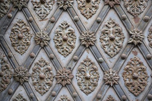An ornate antique metal background.
