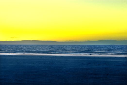 highly saturated vintage colour brean beach, somerset england looking out to sea at sunset to quantock hills