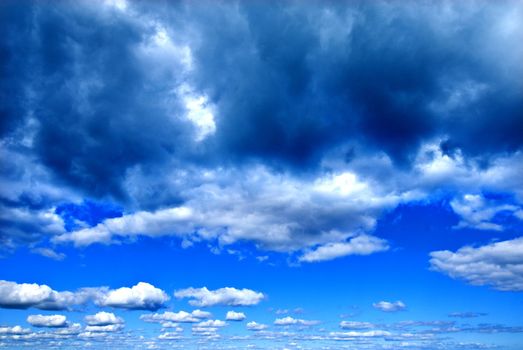 moody clouds layered into distance with blue skies, pembrokeshire, wales