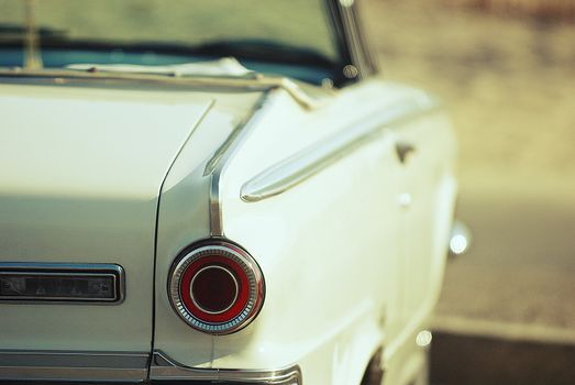 looking from behind, 1960's american convertible classic car at beach