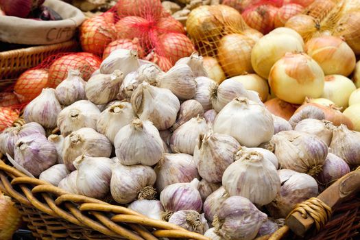 Garlic and Onion Bulbs Display at Public Market Vegetable Stall Closeup