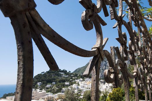 looking through metal fence at scenery of capri italy