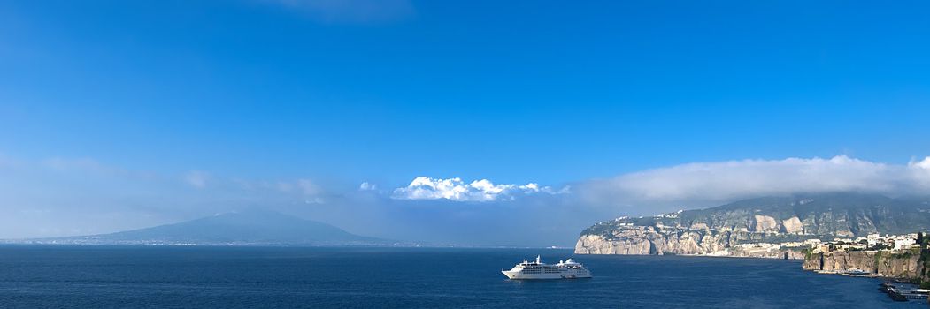 Panoramic across Bay of Naples to Versuvius with cruise ship daytime with blue skies