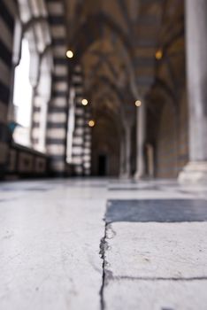 patterned architecture columns and floor amalfi, italy with tour group in background