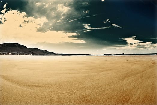 wide empty beach gower wales with vintage colours