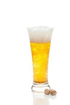 light beer with the foam in a tall glass and pistachios isolated on white