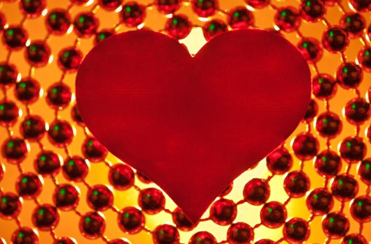 Silk red heart on a light background.