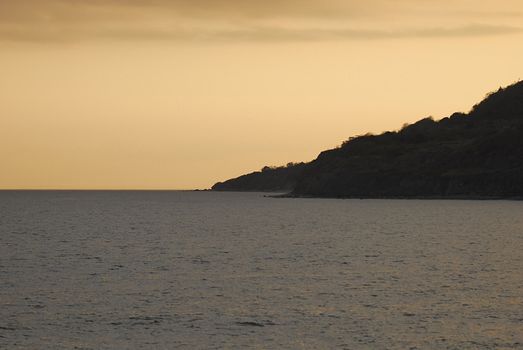 scilouetted cliffs going into english chanel at sun set