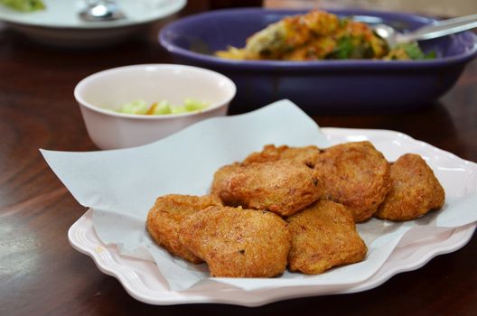 Spicy fried fish cake (Tod Mun Pla) served with cucumber in sweet sauce