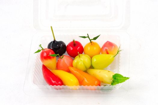 Thai dessert in plastic tray on white background.