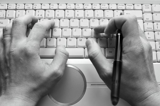 Man typing on laptop keyboard