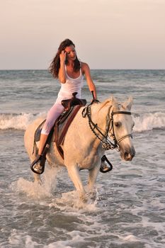 beautifu lwhite horse in the sea and beautiful woman