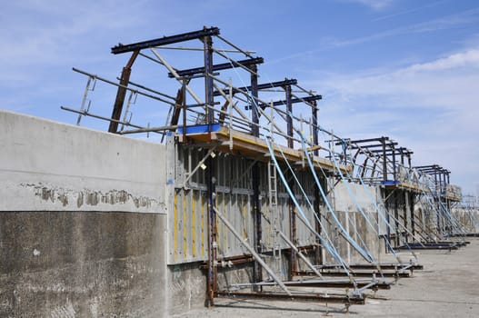 Builder's Yard with scaffoldings which repair a concrete jetty