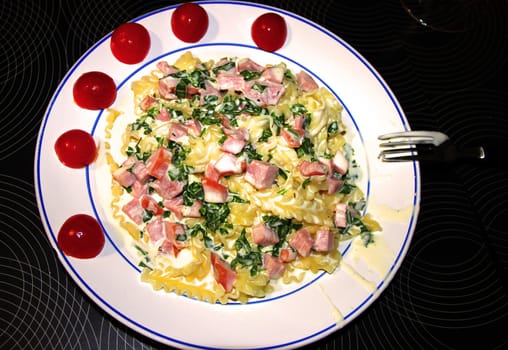 Spaghetti with cream sauce and ham. Italian Cuisine