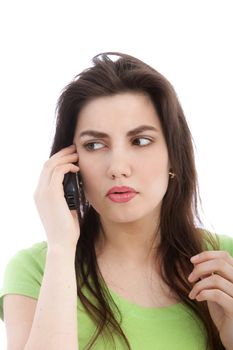 Portrait of serious woman listening to someone through her cellular phone
