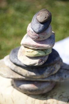 stones piled on each other against the background of grass