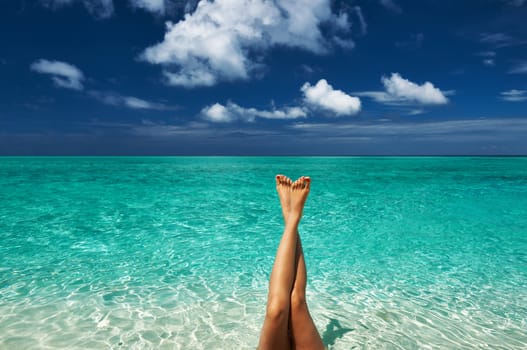 Woman's beautiful legs at beach 