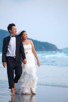 happiness and romantic Scene of love newlywed couples walking on the Beach