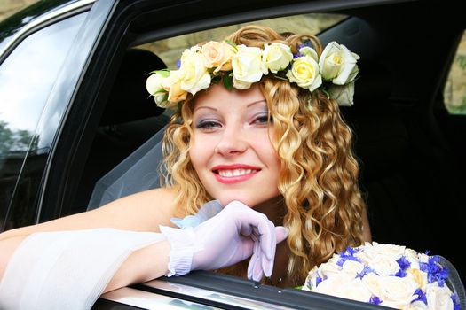 Bride sits in the car