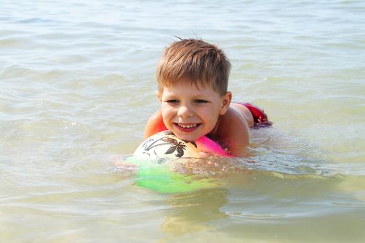 A boy swims in the sea