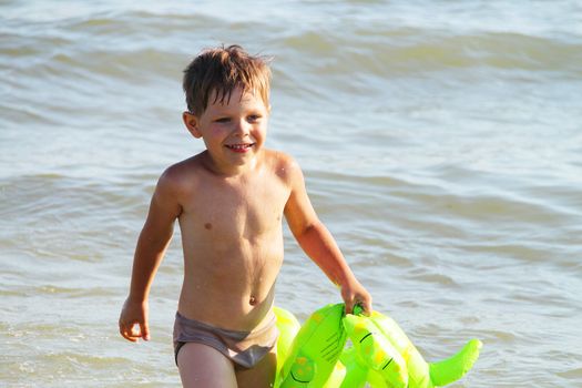 A boy swims in the sea