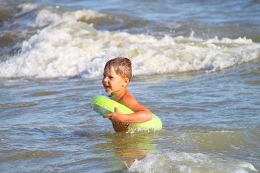 A boy swims in the sea