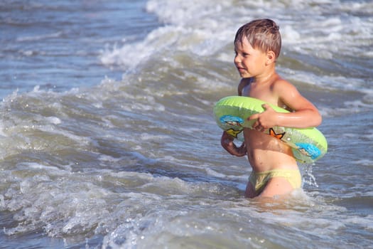 A boy swims in the sea