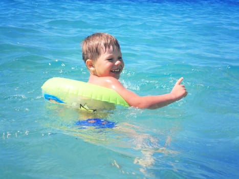 A boy swims in the sea