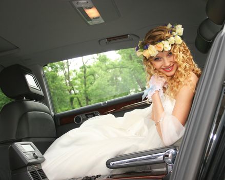 Bride sits in the car