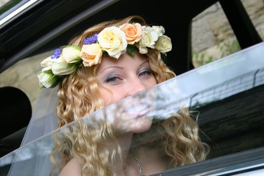 Bride sits in the car