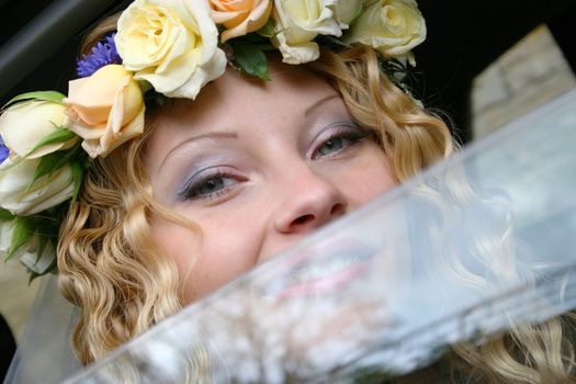 Bride sits in the car