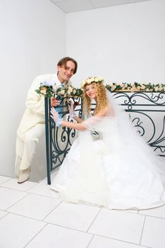 Young couple posing in a studio on the wedding day 