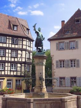 Statue and Fountain in central square of Colmar, France 