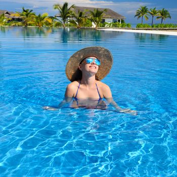 Woman in hat at the pool