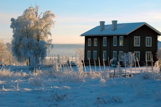 Winter landscapes with a large red house