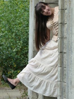 Young brunette girl walks in the park