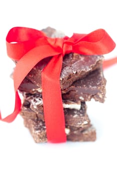background of stack of chocolate with red ribbon